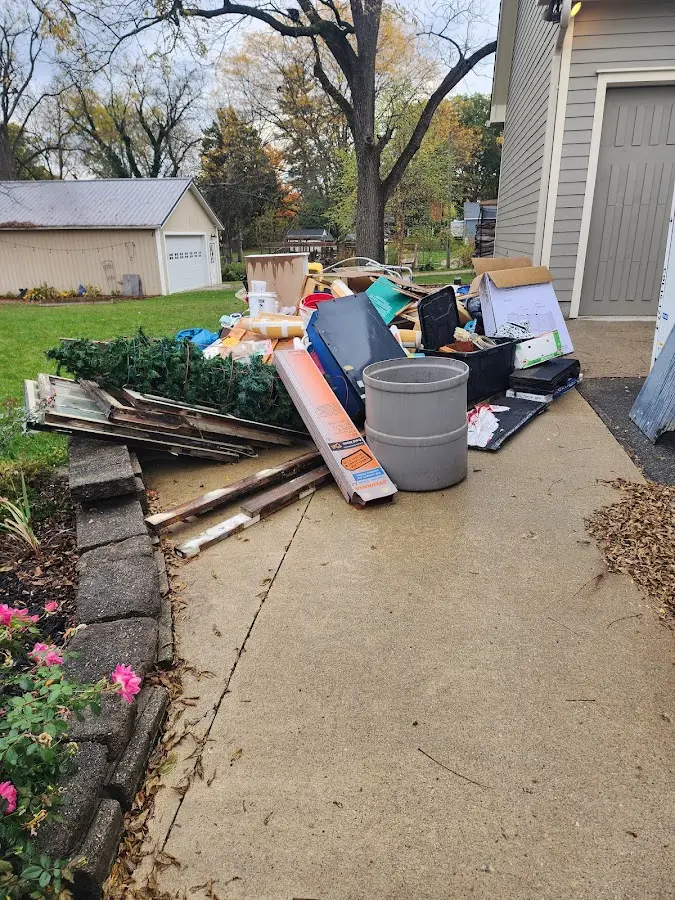 Dumpster being loaded with debris for Demolition Dumpster Rental in Red Bank